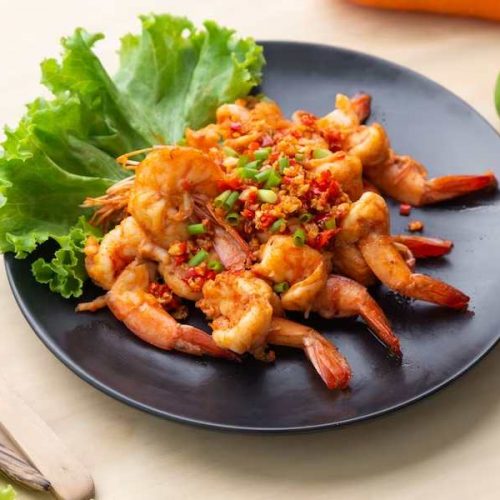 fried-shrimp-with-pepper-salt-black-plate-wooden-table_34168-1040