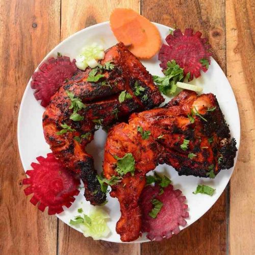 tandoori-chicken-prepared-by-roasting-chicken-marinated-yoghurt-spices-tandoor-served-wooden-rustic-background-selective-focus_726363-873